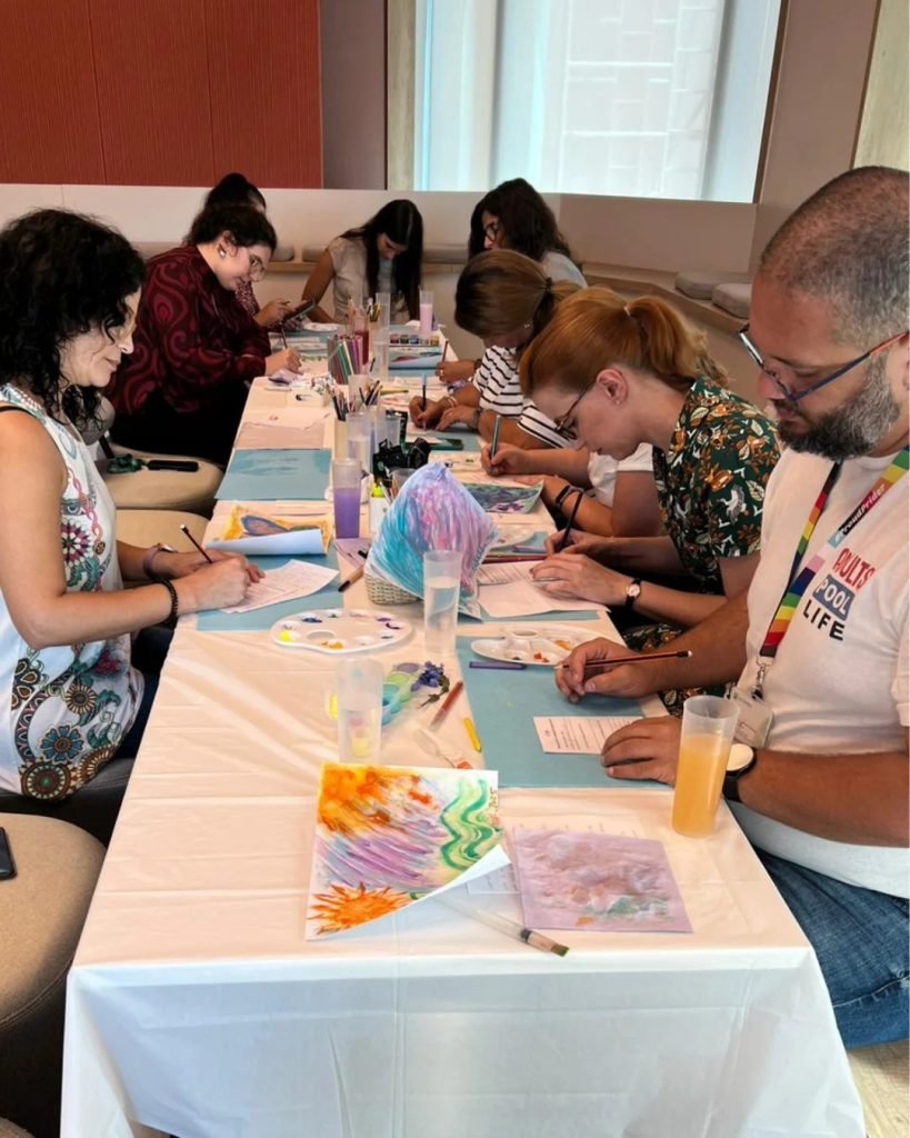 Partners in reflective mask painting workshop exploring relationship identity and belonging together Lisbon