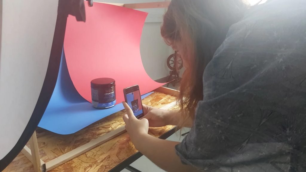 Student practicing studio lighting techniques with softboxes during camera mastery workshop Sintra