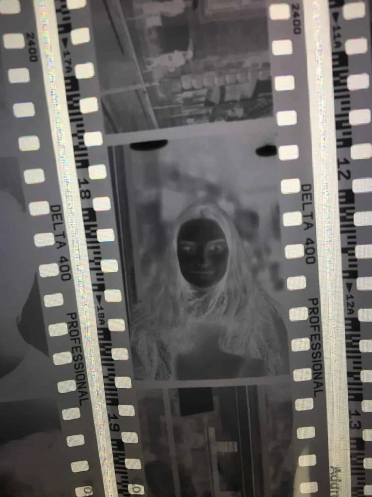 Beginner loading 35mm black and white film during analog photography workshop in Lisbon