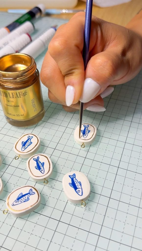 Finished hand-painted jewelry pieces ready to wear created in creative painting workshop Lisbon