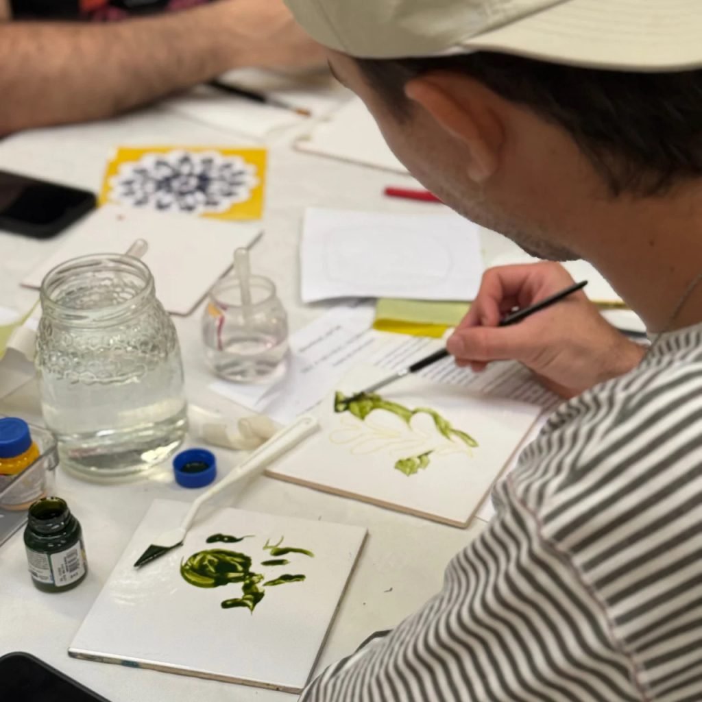 Hand-painted Portuguese azulejo tiles with traditional Porto patterns created by beginners