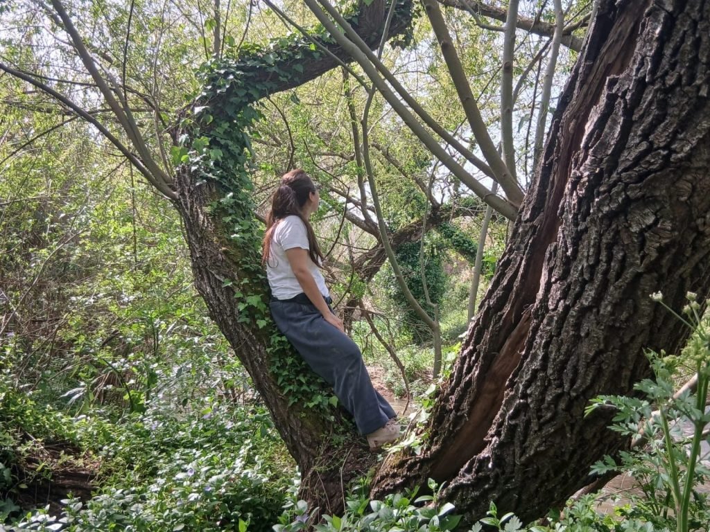 Person practicing Japanese Shinrin-Yoku forest bathing therapy in Sintra woods Portugal nature healing