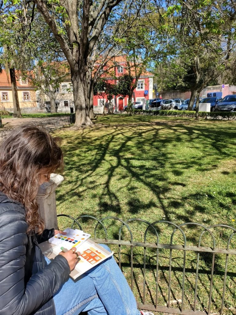 Artist sketching outdoors in Lisbon spring perfect natural light conditions urban workshop
