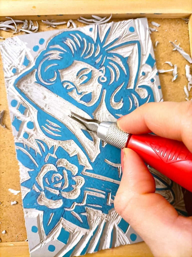 Person carving linoleum printmaking mindful focus flow state creative meditation workshop Lisbon